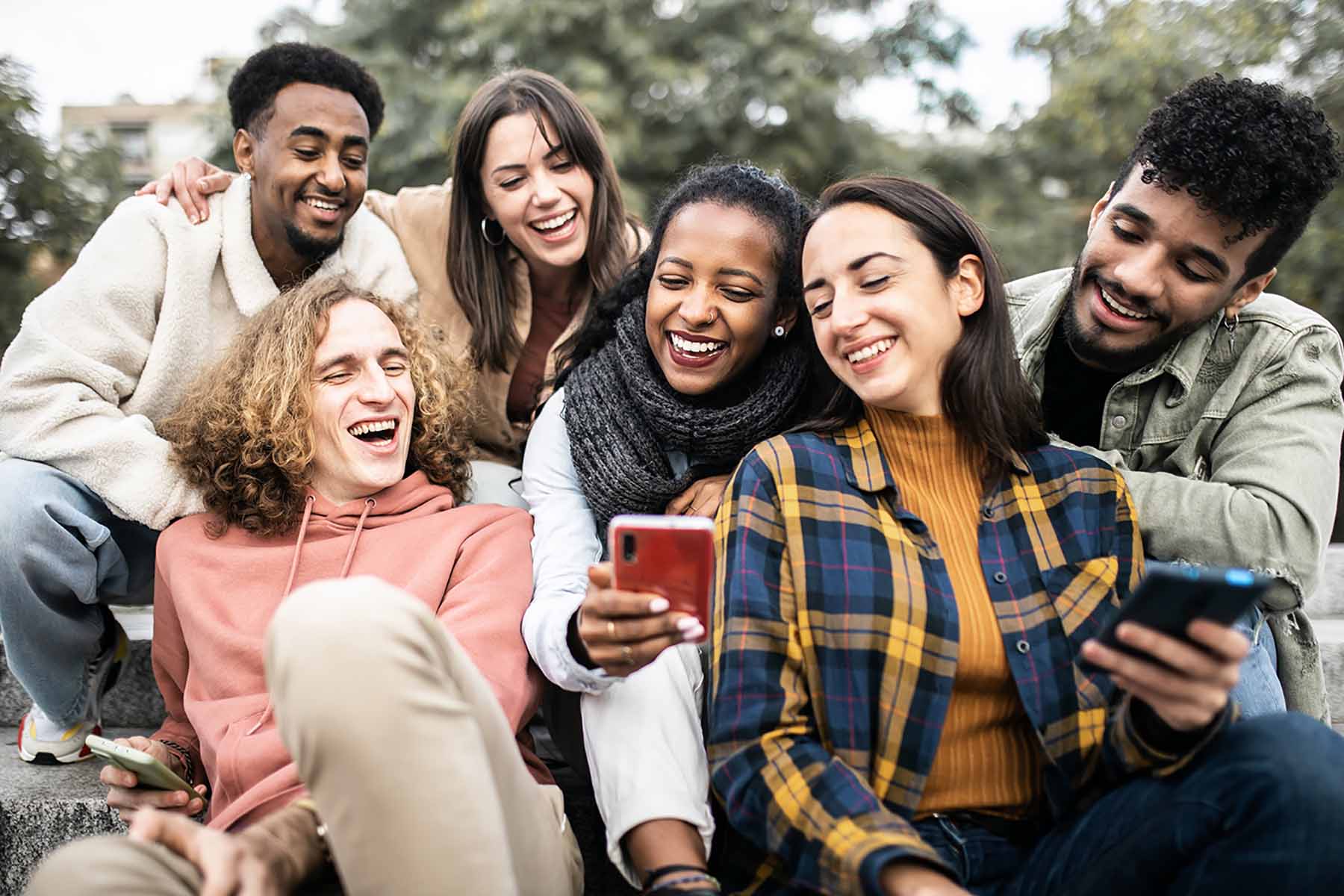 Happy group of young people having fun sharing video content on social media platform